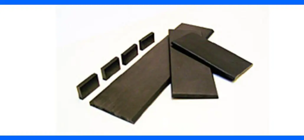 Five large and four small rectangular black carbon strips arranged on a white surface.