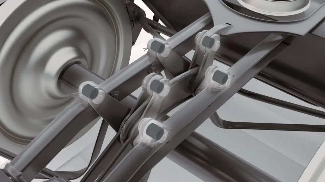 14-wp-brake-linkage-bushes-rail-tds-in-situ2 Close-up view of a car suspension system, showing various arms, bushings, and a wheel assembly.