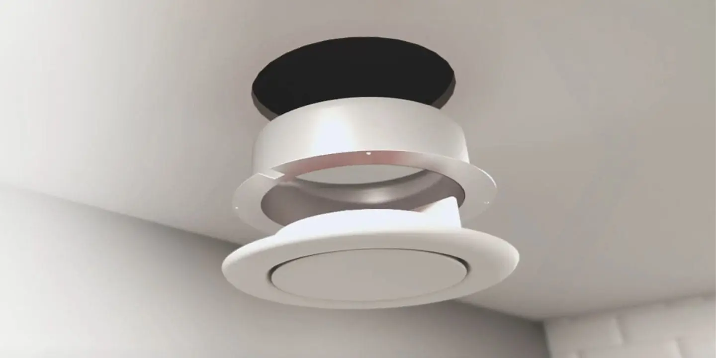 A round ceiling vent partially detached with a visible hole above it.