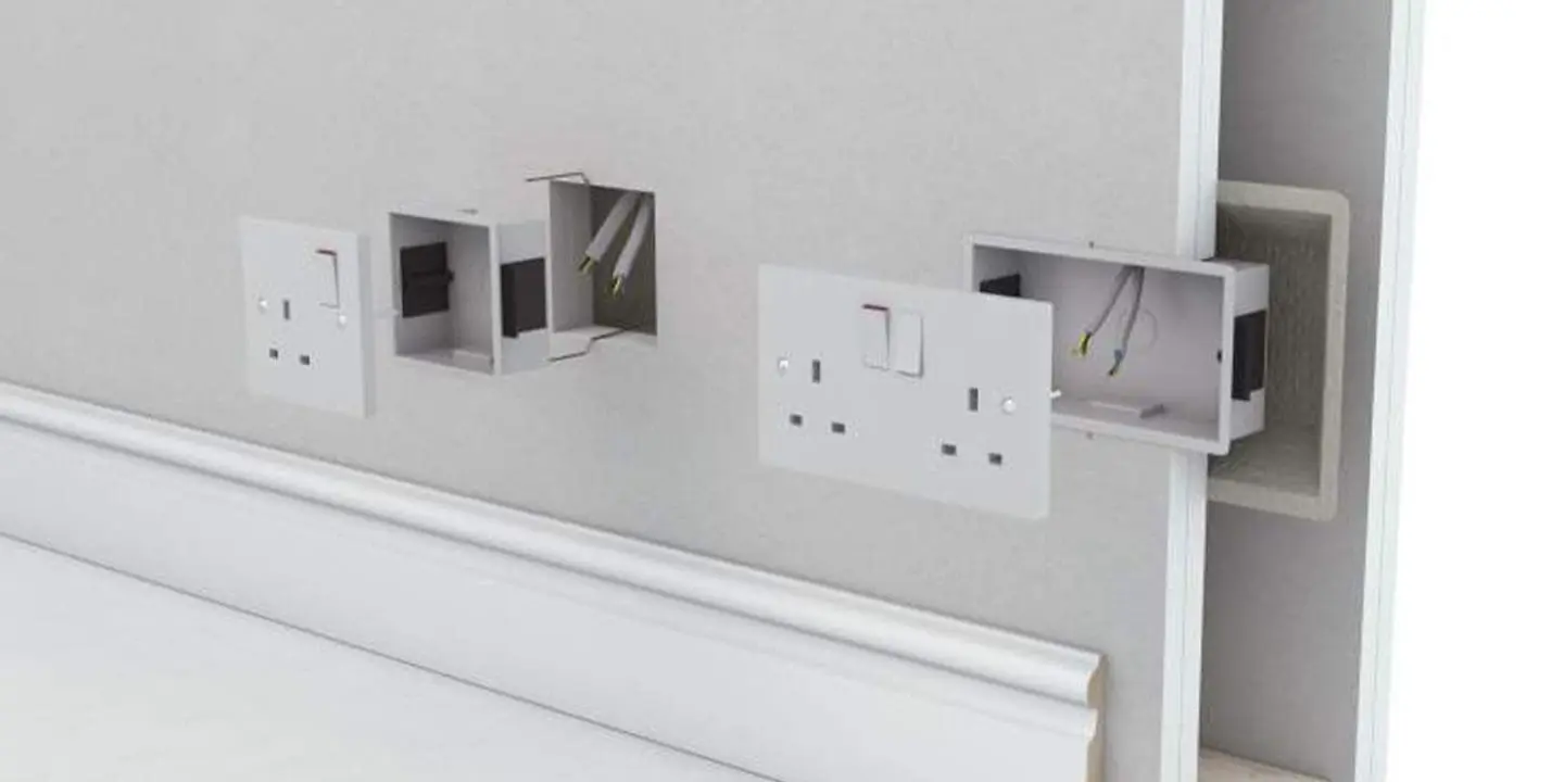 Three electrical outlets being installed on a wall, with exposed wires and open socket boxes.