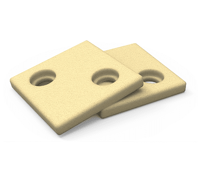 Two beige square cookies with two round holes in each, stacked slightly askew on a white background.