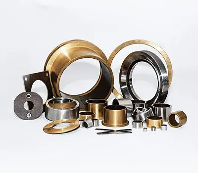 Assorted metal and brass machine parts and rings displayed on a white background.