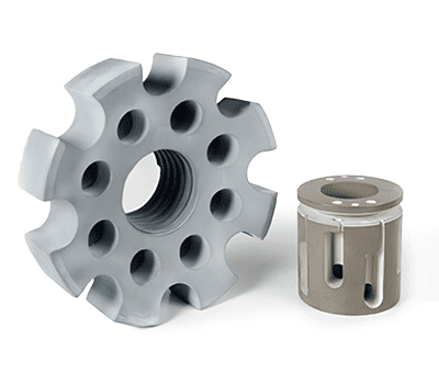 Two gray, cylindrical mechanical parts with holes, one larger and gear-shaped, the other smaller and smooth.