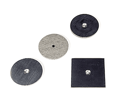 Four washers: three round and one square, all with center holes, on a white background.