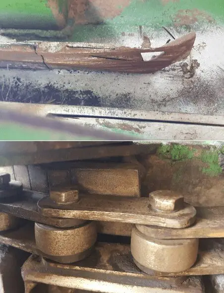 Close-up of a broken, rusted metal part and a chain mechanism with gears and rollers.