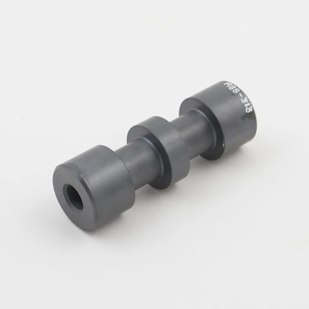Cylindrical black composite or polymer component with stepped sections and a central bore, shown on a plain light background.