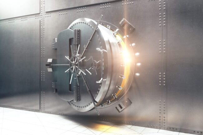 Sep 27 2022 A large steel bank vault door slightly open with bright light shining from inside.