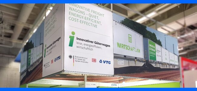 innovative-freight-wagons Exhibition booth with banners about innovative, quiet, energy-efficient, and cost-effective freight wagons.