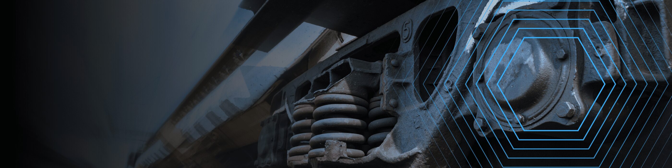 Close-up of a train wheel assembly with blue hexagonal graphics overlaying the right side.