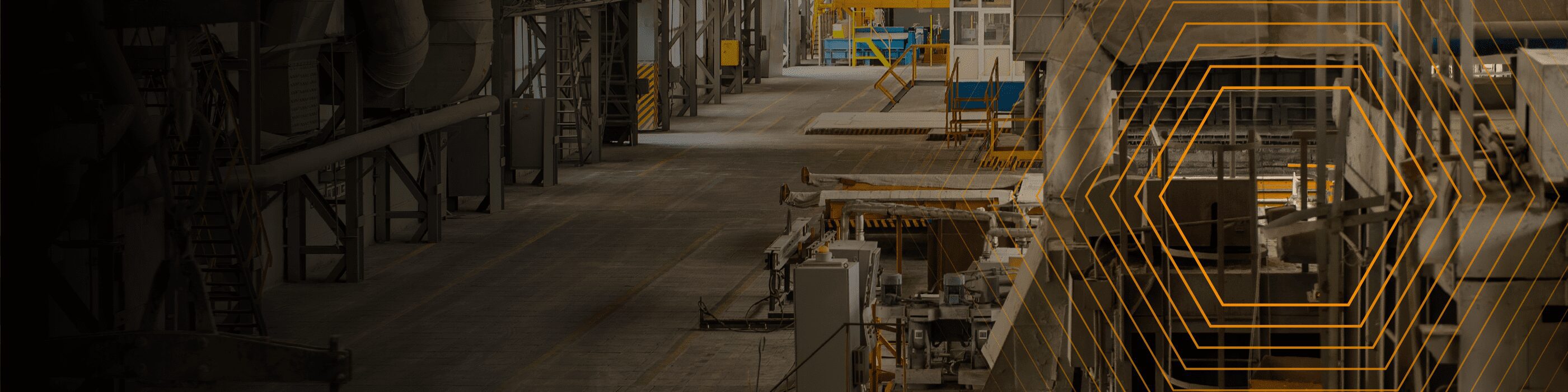 Wide view of an empty industrial factory interior with yellow geometric lines overlay on the right side.