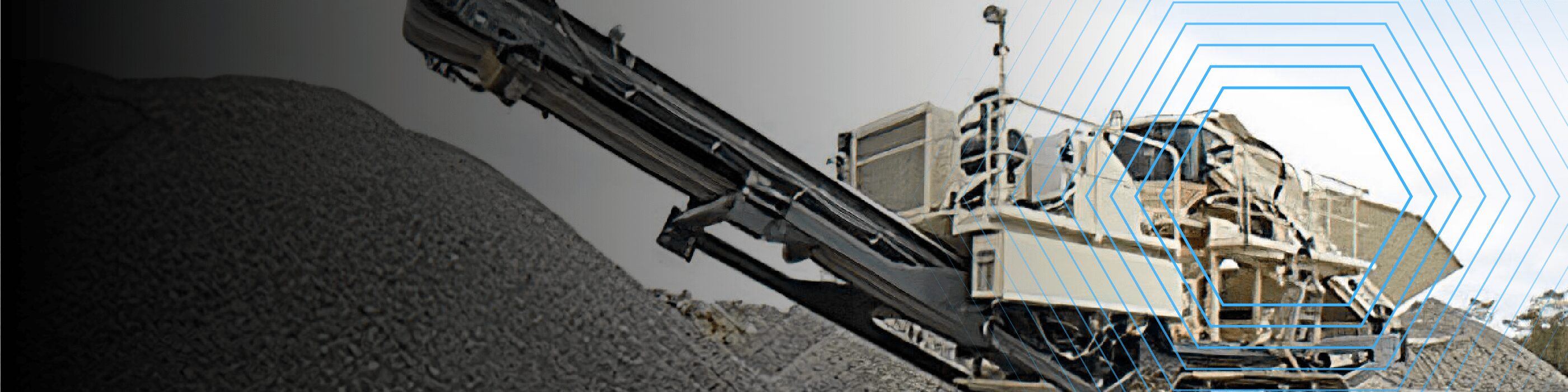 A large industrial rock crusher machine processes gravel into piles at a construction site.