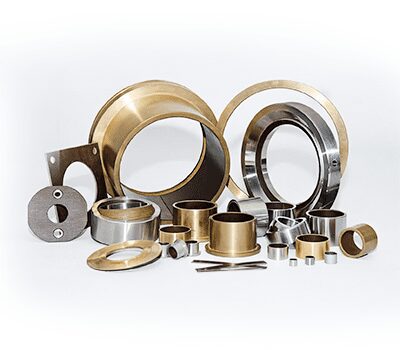 Various metallic mechanical components, including rings, bushings, and washers, arranged on a white background.